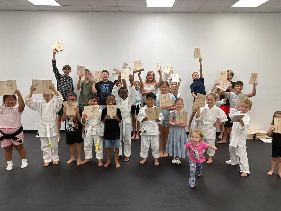 Legacy Martial Arts students after a board breaking session