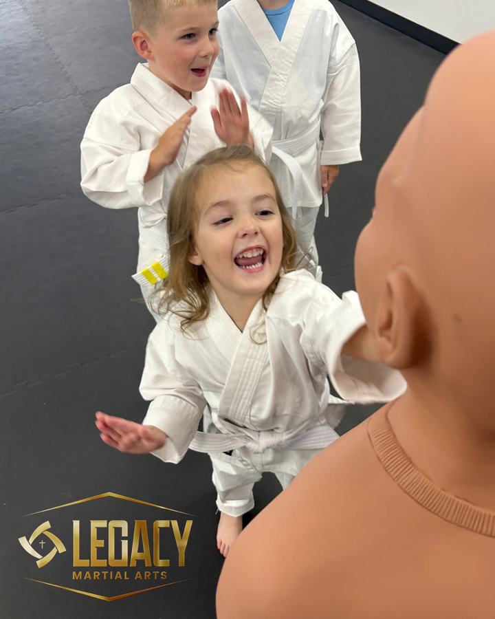 Preschool student laughing during a striking drill at Legacy Martial Arts